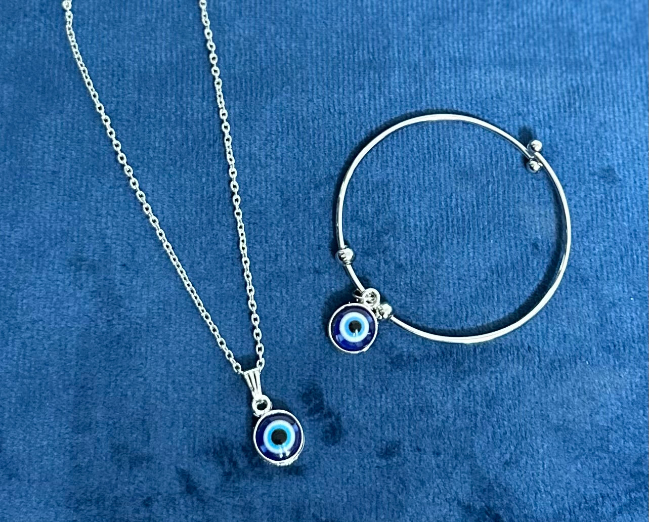 Combo of Silver Colored Blue Evil Eye Adjustable Hand Bracelet and Pendent Chain.