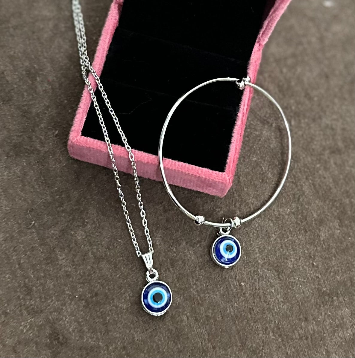 Combo of Silver Colored Blue Evil Eye Adjustable Hand Bracelet and Pendent Chain.